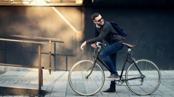 happy male commuter on bicycle | How to Take Advantage of a Flexible Schedule https://positiveroutines.com/flexible-schedule-tips/