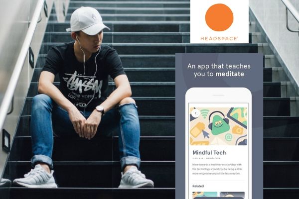male with earbuds sitting on stairs screenshot of headspace app overlayed | 11 Things You Need to Have a Productive Day https://positiveroutines.com/have-a-productive-day/
