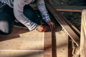 person on knees marking wood to be cut | How to be Selfless This Valentine's Day https://positiveroutines.com/how-to-be-selfless/