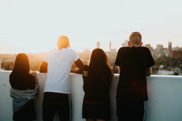 rearview of four people overlooking a city | How to be Selfless This Valentine's Day https://positiveroutines.com/how-to-be-selfless/ 