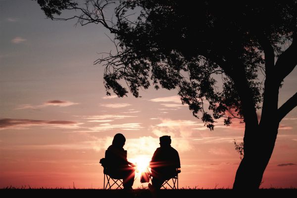 silhouette of two people sitting in sunset talking | How to be Selfless This Valentine's Day https://positiveroutines.com/how-to-be-selfless/ 