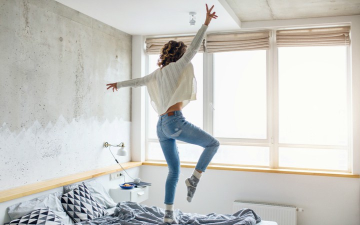 woman jumping on bed in morning | 21 Quotes to Start the Day in A Good Mood https://positiveroutines.com/quotes-to-start-the-day/ ‎