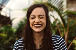 woman with big smile and eyes closed | 7 Easy Ways to Build a More Positive Mindset https://positiveroutines.com/positive-mindset/