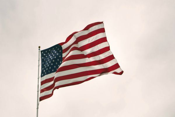 american flag waving in wind | The Happiest Country in the World This Year is... https://positiveroutines.com/happiest-country-in-the-world/