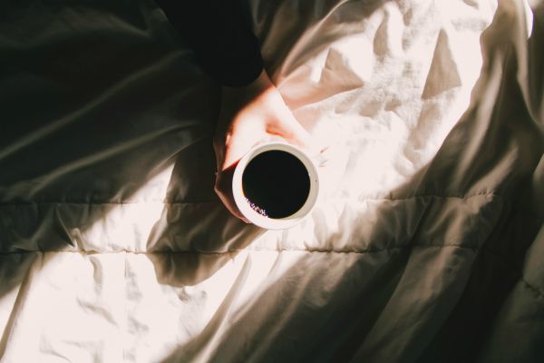 cup of black coffee in sunlight | 13 Gratitude Journal Prompts to Try This International Day of Happiness https://positiveroutines.com/gratitude-journal-prompts/