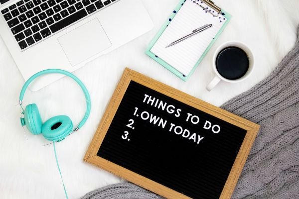 desk with message board saying things to do 1 own today | 13 Gratitude Journal Prompts to Try This International Day of Happiness https://positiveroutines.com/gratitude-journal-prompts/