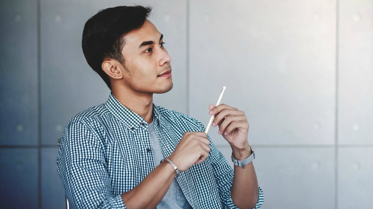 happy pensive male at work | The Curious Case of Success and Luck https://positiveroutines.com/success-and-luck/