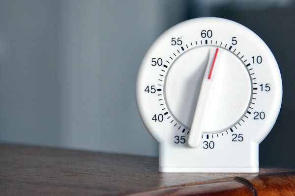 kitchen timer on desk | What is Procrastination? Causes, Effects, & How to Stop Procrastinating https://positiveroutines.com/what-is-procrastination/