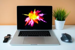 laptop with explosion of color on screen | An Email Organization Tip for Real People + Why We’re Totally On Board https://positiveroutines.com/email-organization-strategy/