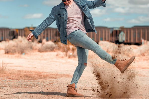 man in denim kicking dirt | What is Procrastination? Causes, Effects, & How to Stop Procrastinating https://positiveroutines.com/what-is-procrastination/