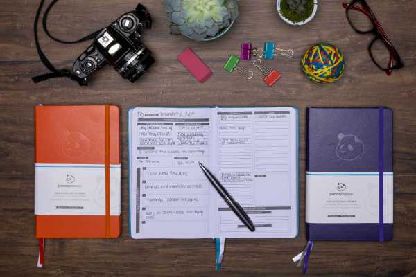 open panda planner on desk beside orange and purple panda planners | 3 Time-Management Tools to Up Your Organization and Simplify Your Life  https://positiveroutines.com/time-management-tools/
