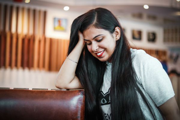 shy happy girl in cafe | What is Procrastination? Causes, Effects, & How to Stop Procrastinating https://positiveroutines.com/what-is-procrastination/