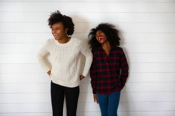 two women laughing | The Happiest Country in the World This Year is... https://positiveroutines.com/happiest-country-in-the-world/