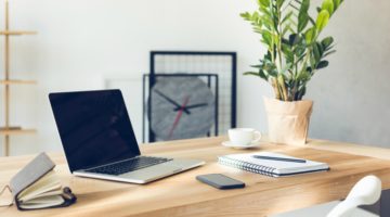 clean desk with laptop notebooks and mobile device | 3 Tools to Improve the Life of an Entrepreneur https://positiveroutines.com/life-of-an-entrepreneur-tools/
