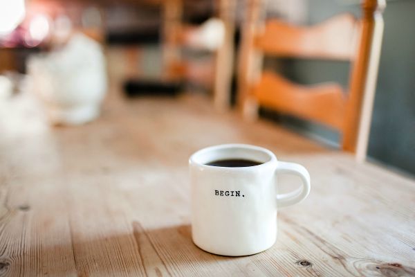 full coffee mug says begin | 7 Science-Backed Secrets of a Productive Morning Routine  https://positiveroutines.com/productive-morning-routine/