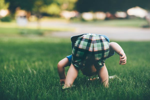toddler boy bent over in grass | Why is Nature Important to Happiness  https://positiveroutines.com/why-is-nature-important-happiness/