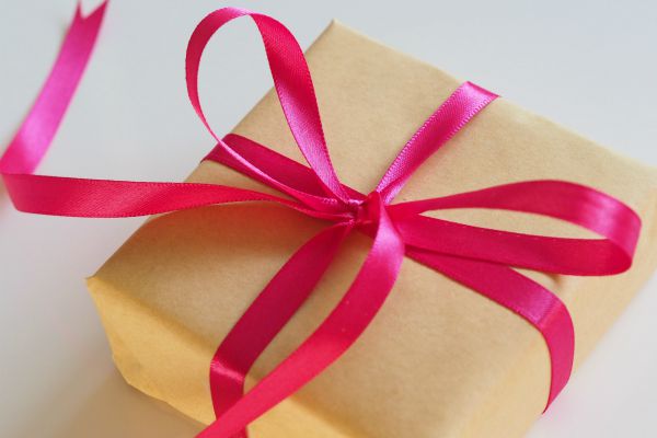gift box wrapped in pink ribbon | Graduation Gift Guide: The Best Planner for Every Grad https://positiveroutines.com/graduation-gift-guide/