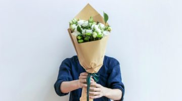 man holding bouquet of white flowers | 15 Mother's Day Quotes to Say Thanks This Year https://positiveroutines.com/mothers-day-quotes/