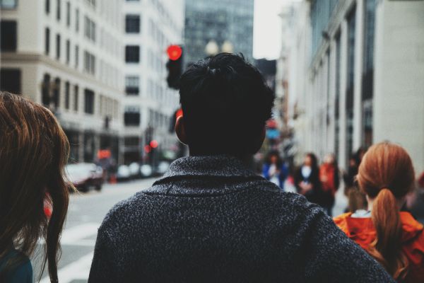 man walking down city sidewalk | The Best Guided Meditations for Sleep, Stress, and More https://positiveroutines.com/best-guided-meditations/