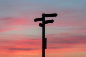 multi directional sign post in sunset | 3 Ways Being Too Busy Hurts Your Productivity https://positiveroutines.com/too-busy-productivity/