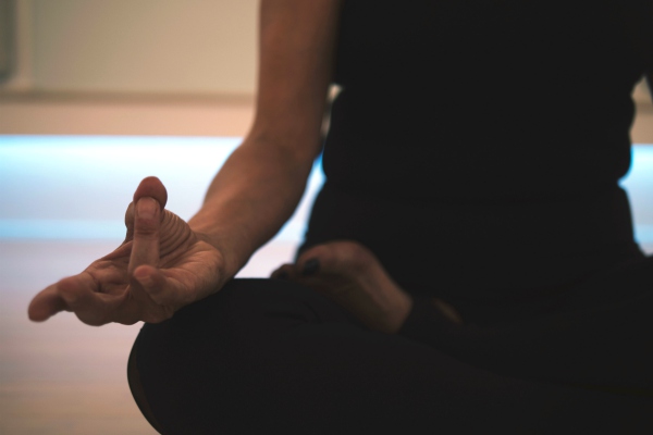 closeup of womans hand during meditation pose | 7 Ways Downtime at Work Makes You More Productive https://positiveroutines.com/downtime-at-work