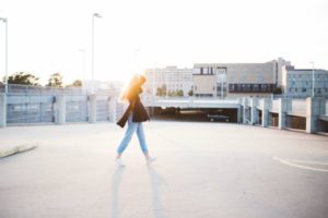 woman walking around parking lot | Why Does Exercise Make You Happy https://positiveroutines.com/why-does-exercise-make-you-happy/