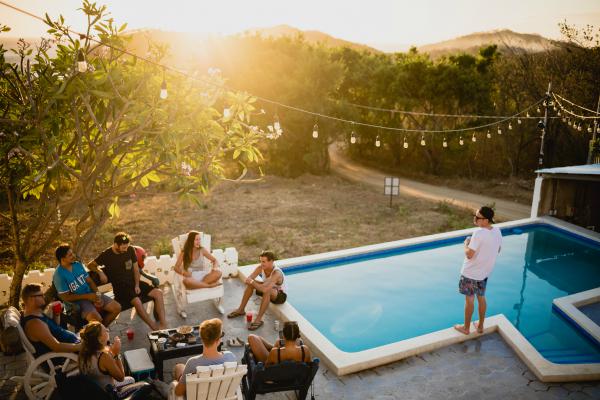 group of friends at pool party | 7 Things to Do on the Fourth of July That Will Make You Happier https://positiveroutines.com/things-to-do-on-fourth-of-july/