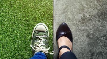 one casual sneaker on grass one dress shoe on concrete | Is Work and Life Balance Even Achievable in 2019? https://positiveroutines.com/work-and-life-balance-tips/