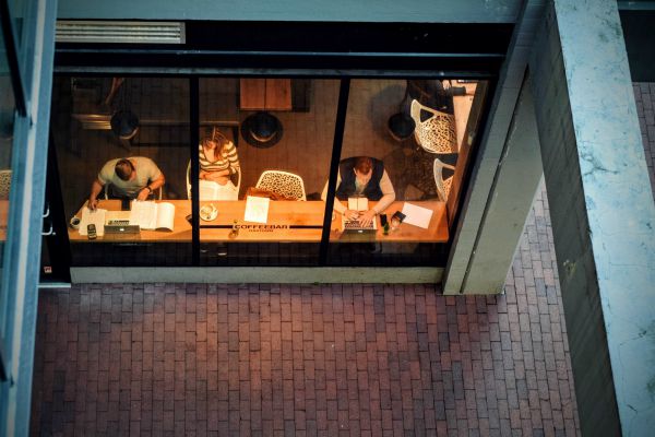 people working into evening at coffee shop | Is Work and Life Balance Even Achievable in 2019? https://positiveroutines.com/work-and-life-balance-tips/