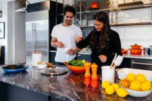 couple preparing dinner together| How to Concentrate in a Digitally Distracting World https://positiveroutines.com/how-to-concentrate/