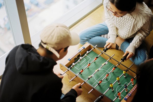 man and woman playing foosball game | What is the Importance of Face-to-Face Communication https://positiveroutines.com/face-to-face-communication/
