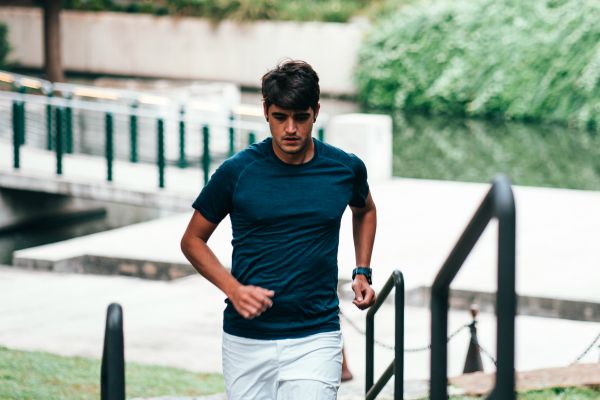 man running stairs outdoors | 7 Natural Ways to Boost Energy, According to Science https://positiveroutines.com/natural-ways-to-boost-energy/
