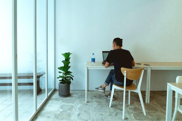 man-working-on-laptop-in-minimalist-space | How to Concentrate in a Digitally Distracting World https://positiveroutines.com/how-to-concentrate/