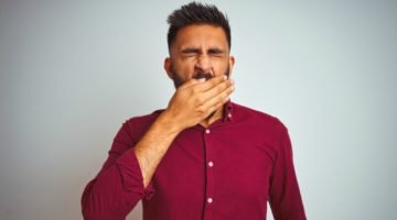 man yawning | 7 Natural Ways to Boost Energy, According to Science https://positiveroutines.com/natural-ways-to-boost-energy/