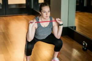 woman doing squats with loop resistance band | A Simple Morning Ritual for a New School Year https://positiveroutines.com/simple-morning-ritual/