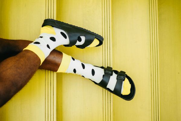 man wearing yellow socks and black sandals | How to Leave Work at Work and Actually Enjoy the Weekend https://positiveroutines.com/enjoy-the-weekend/