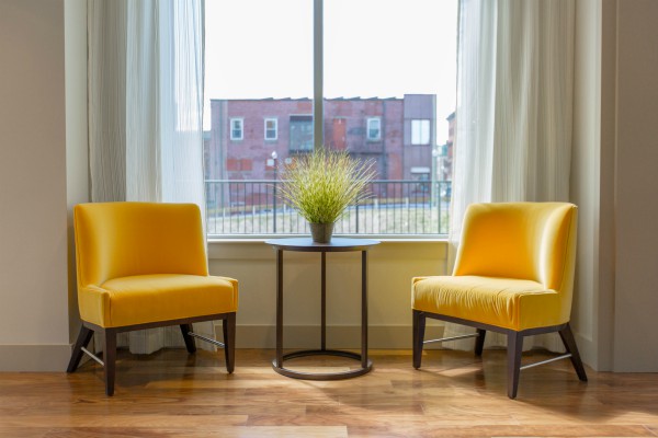 two yellow chairs near large window | New Research Reveals The Essentials of the Best Workspace https://positiveroutines.com/best-workspace/