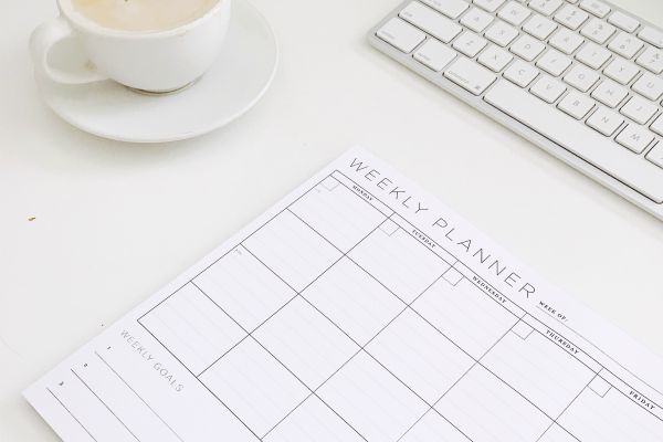 weekly planner on desk | The Happiness-Boosting Magic of Evening Routines https://positiveroutines.com/evening-routines/